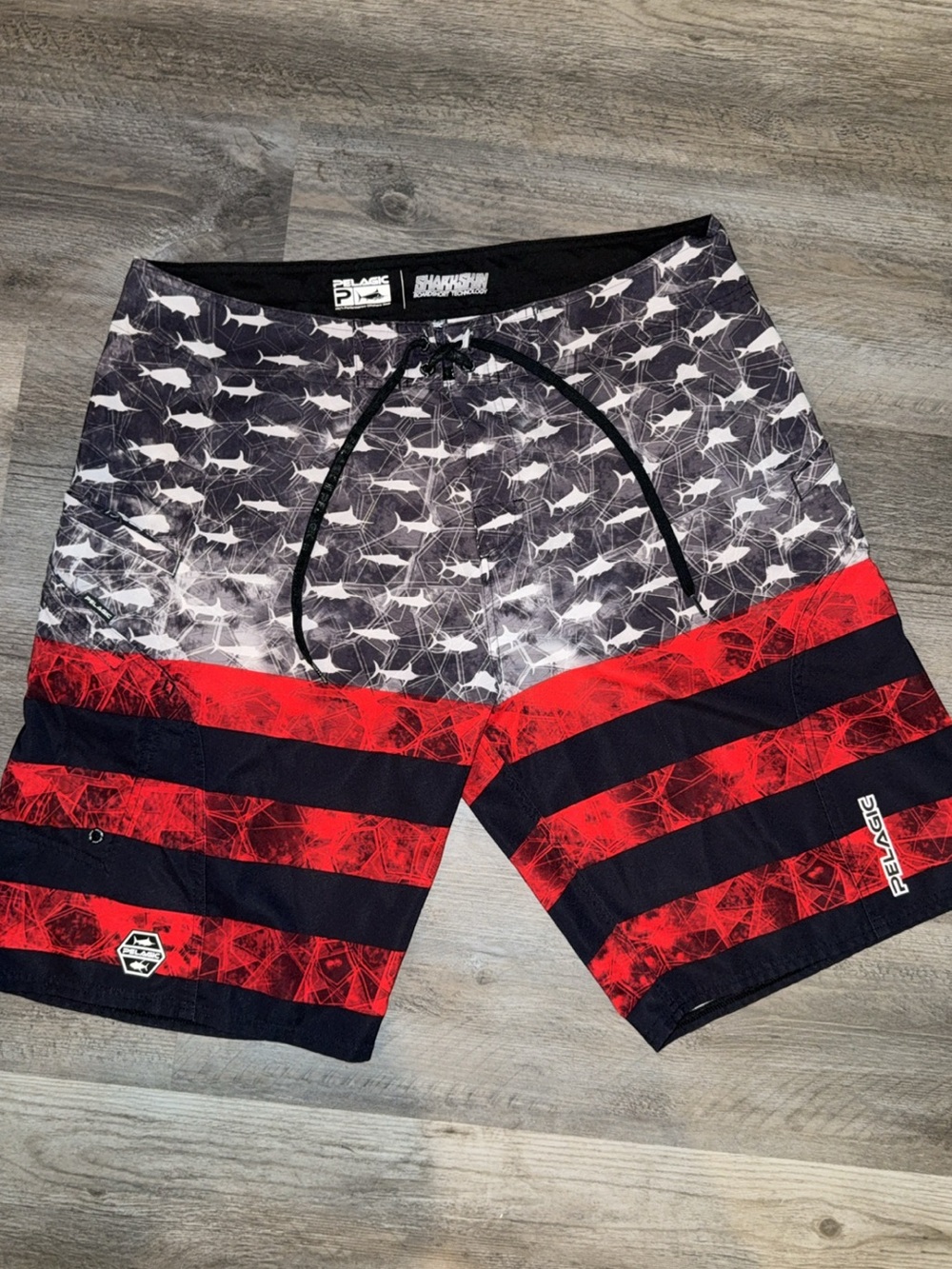 Pelagic Men’s Black, White & Red Shark-Stripe Board Shorts